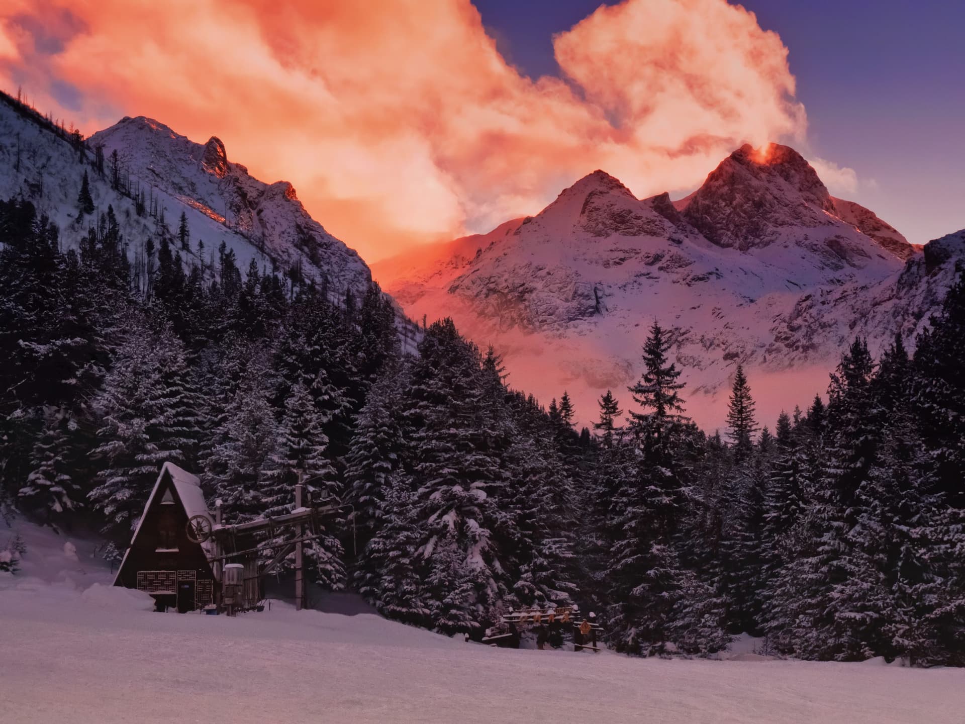 snowy mountain light up pink by sunset