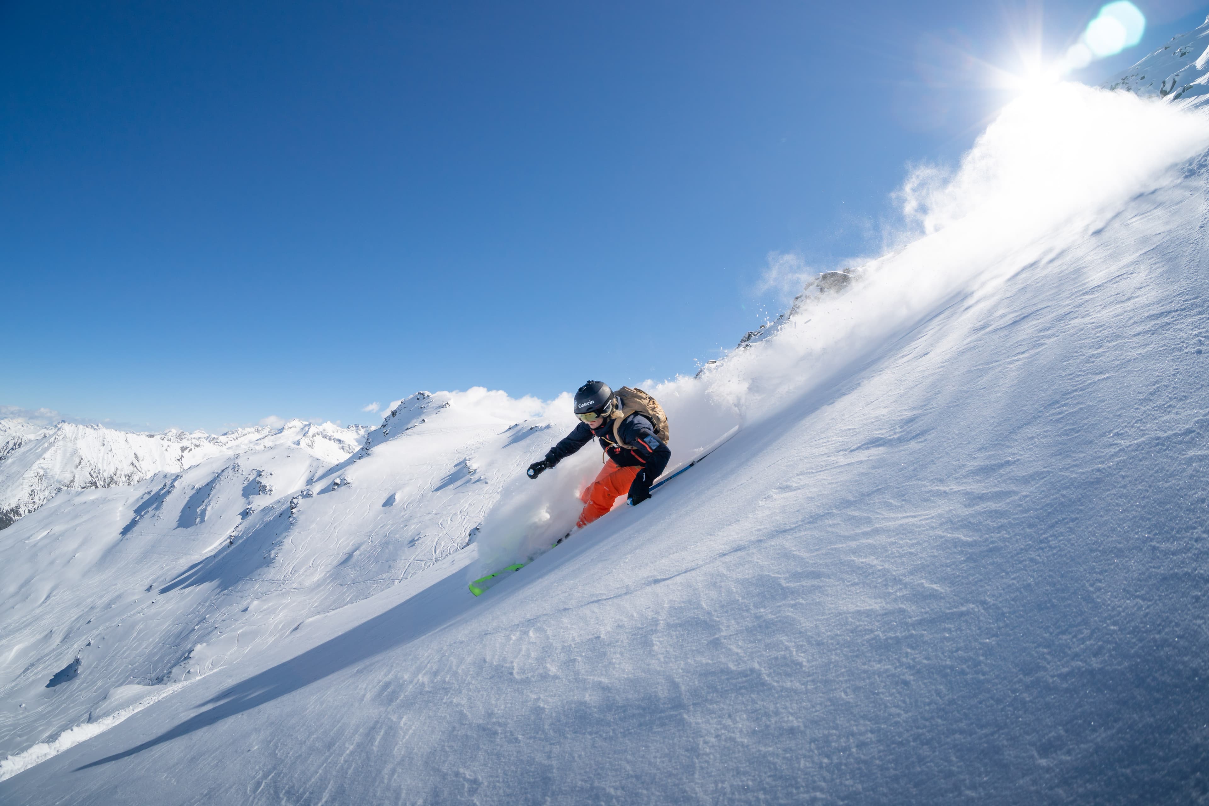 Skiier carving a turn off piste at Bad Gastein ski resort